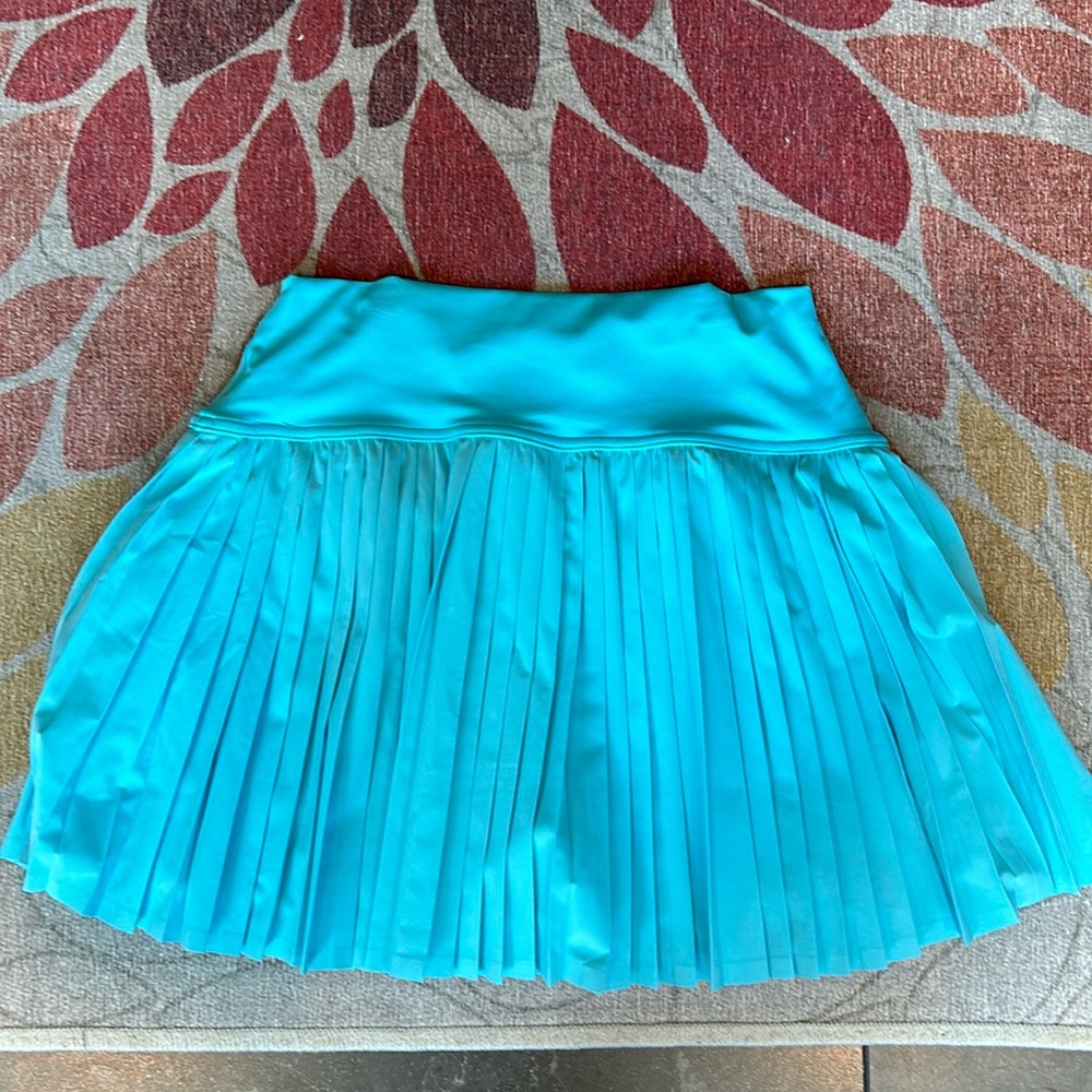 Cute blue pleated tennis skirt. Built in shorts with pockets.